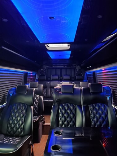 Executive sprinter van interior with leather seating and blue LED lighting