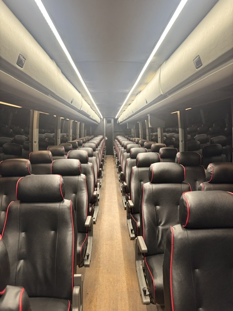 Motor coach interior with black and red leather seating for 54 passengers